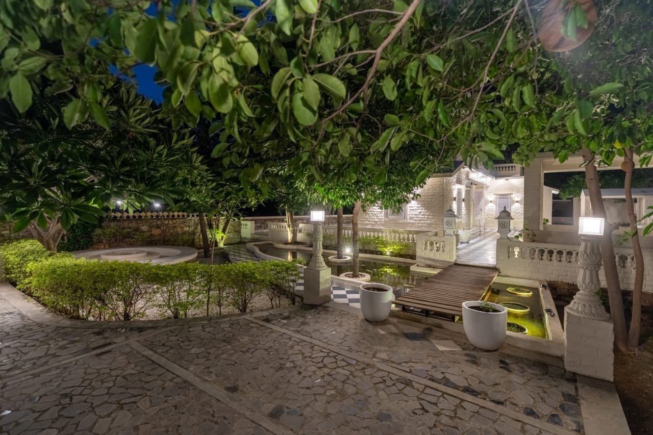 Private pool surrounded by lush orchard at The Riverside Estate Udaipur